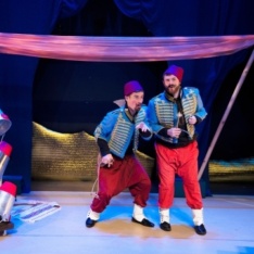 Two singers standing side by side on stage